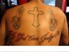 cross symbol tattoo on man's back